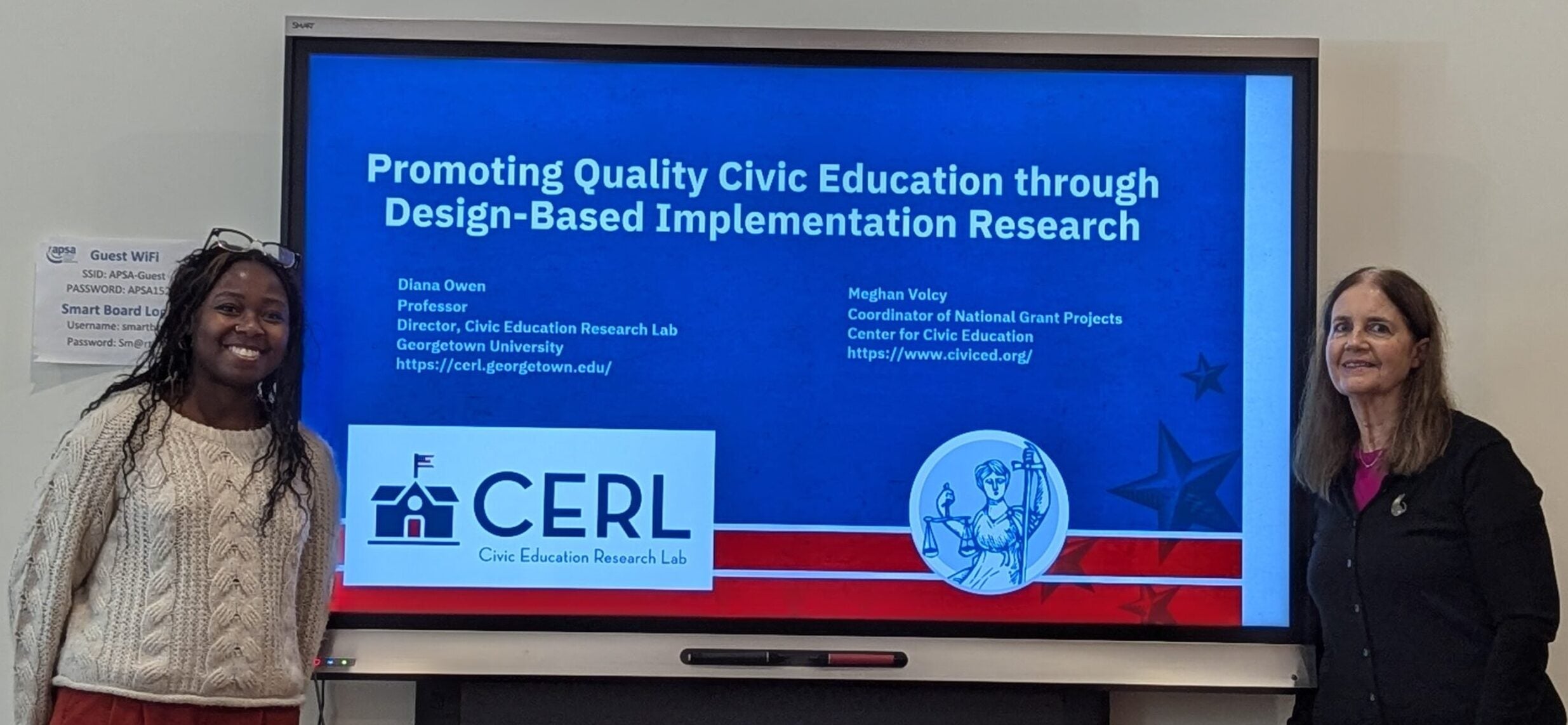 Diana Owen, Georgetown Professor and CERL Director, and Meghan Volcy, Coordinator of National Grant Projects at the Center for Civic Education, stand in front of their joint presentation slides at the October APSA workshop.