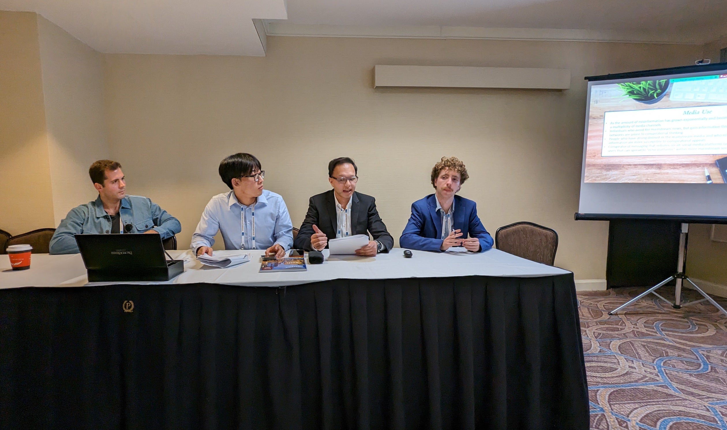 Thom Crockett, Kyle Kim, Arjun Chawla, and Kelton Miller present research on conspiracy theories and voter engagement at the Midwest Political Science Association annual meeting in Chicago.