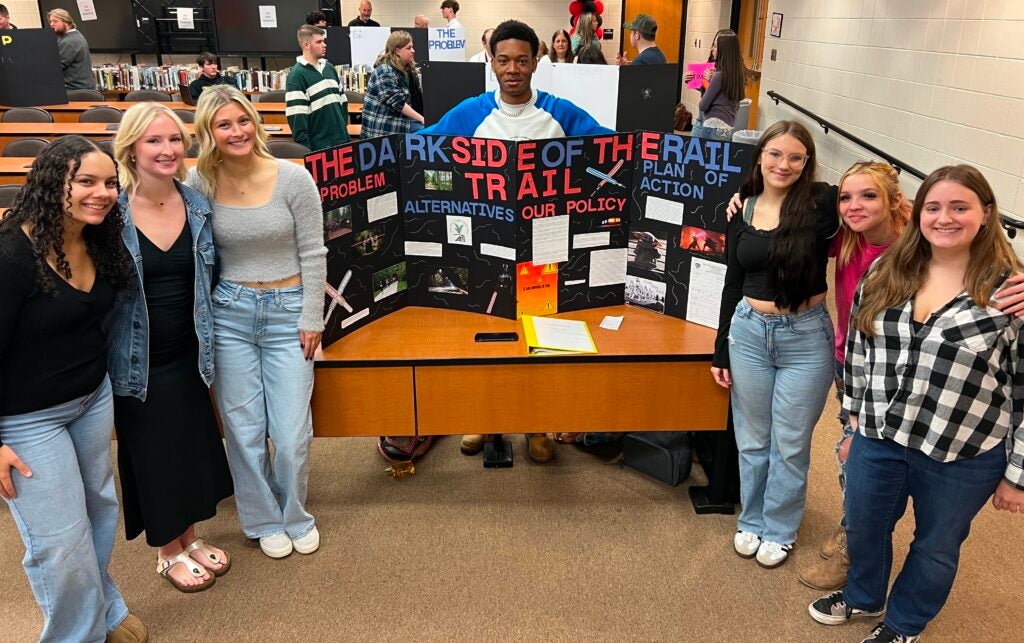 University High seniors display their Project Citizen presentation board