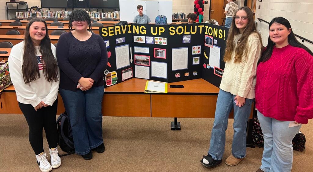 Pictured: One Project Citizen group and their project display board