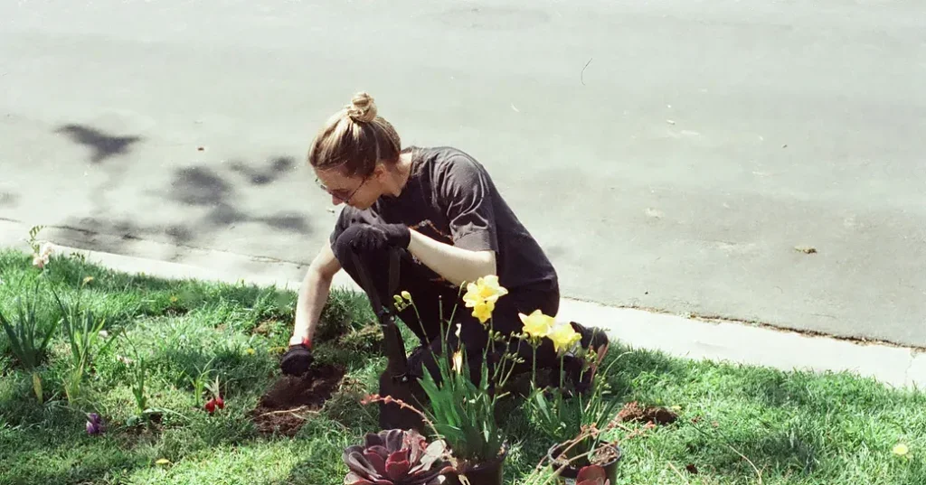 Young woman planting to improve public space