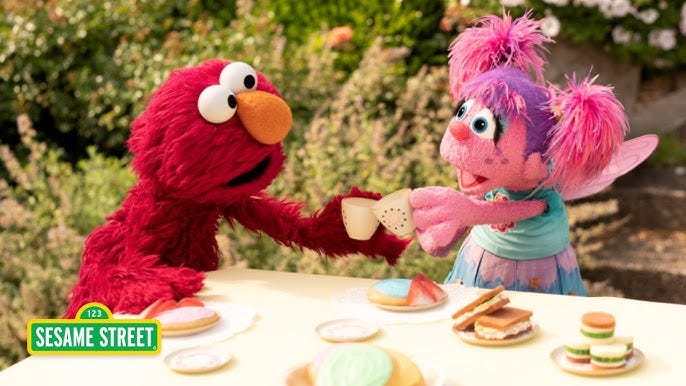Sesame Street characters have tea.