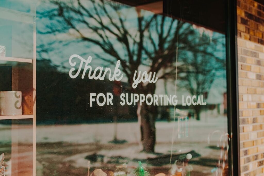 "Thank you for supporting local" written on shop's window.